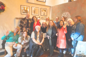 A festive group wearing Santa hats at a wellbeing session